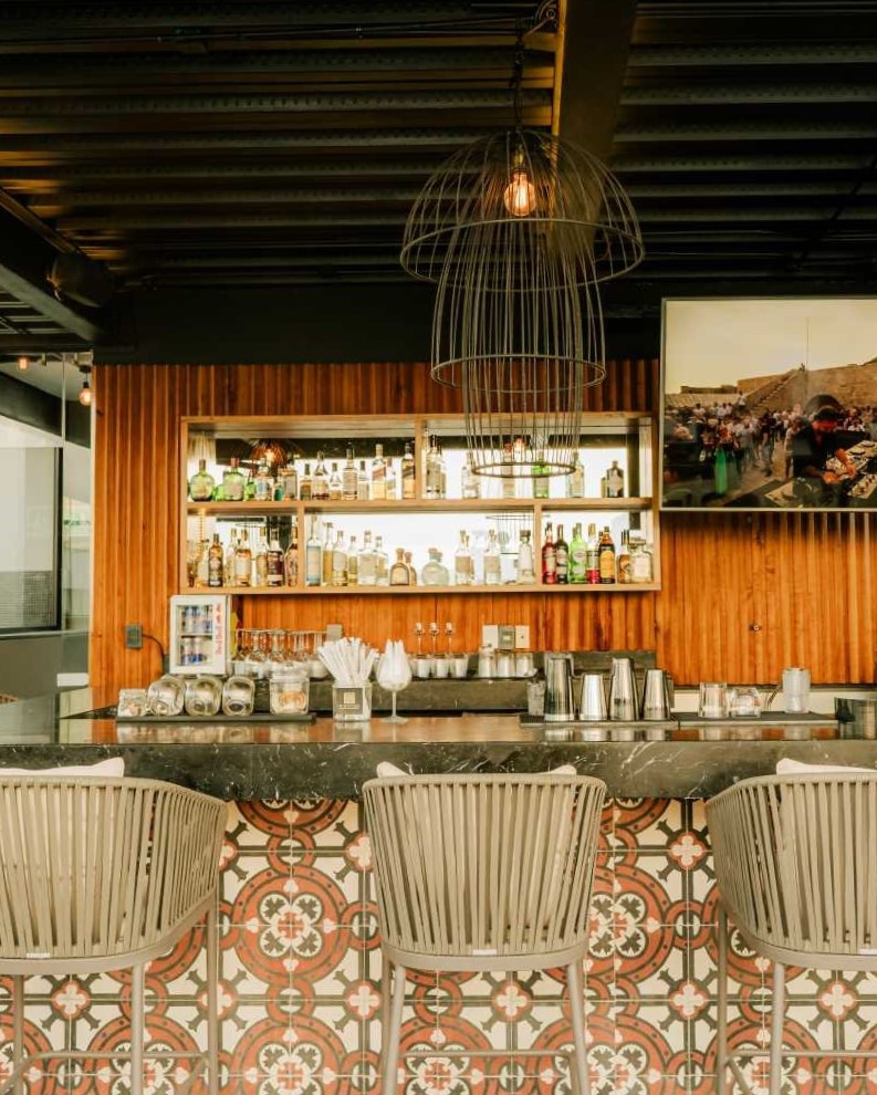 Rooftop bar with comfortable seating at IT Boutique Hotel