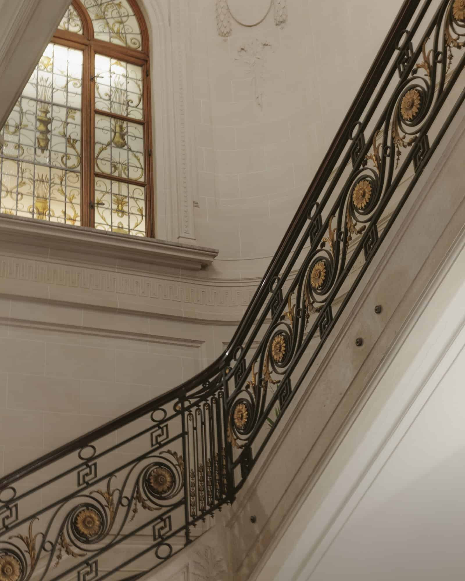 Main staircase with gold decorative details at Hotel Fleur de Ville 