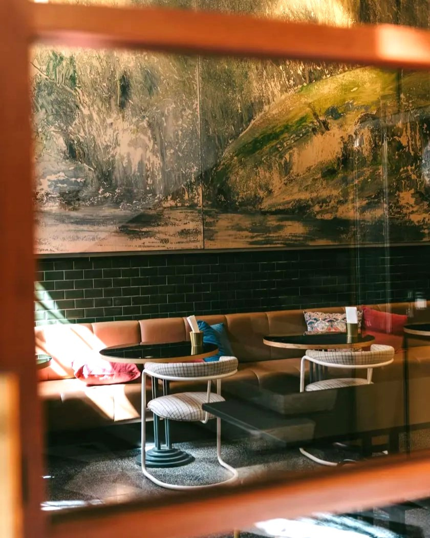 The House Bar at The Editory House Ribeira, featuring a painting of the Douro River.